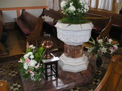 Baptismal font and flowers.